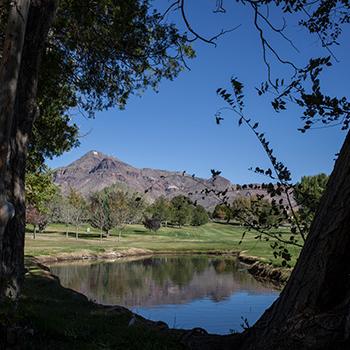 Image of M Mountain with a small pond in the foreground.